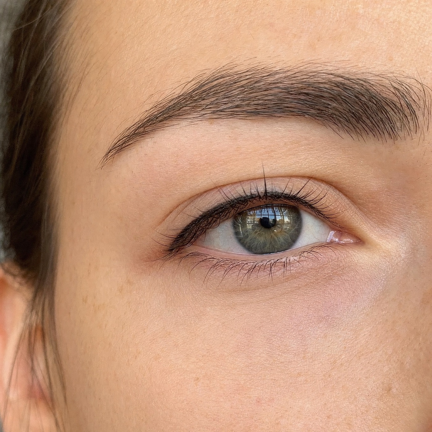 Close-up of healed permanent eyeliner along the upper lash line