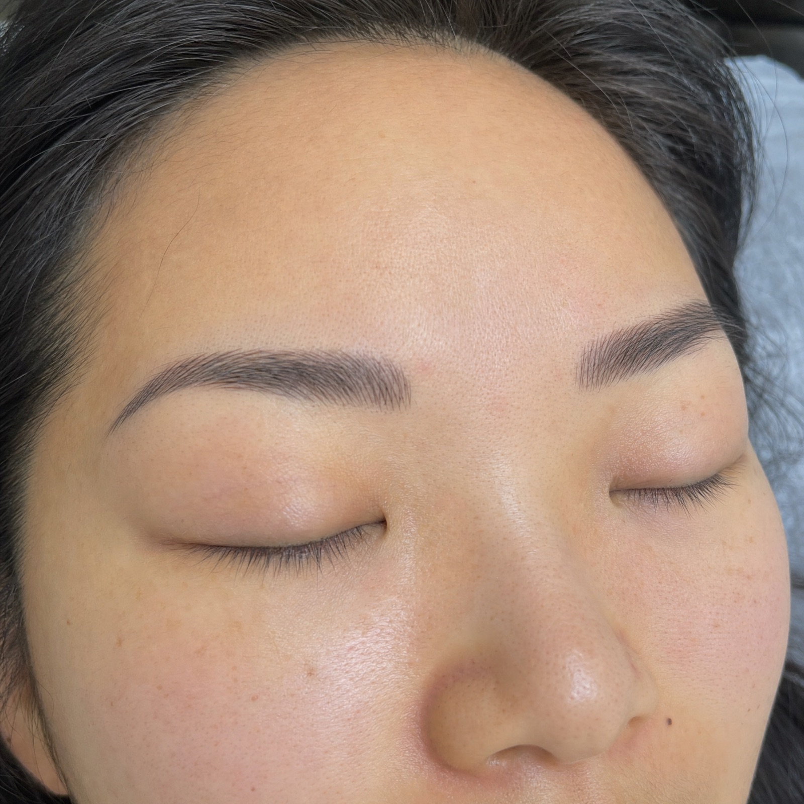 Close-up of soft, natural healed microbladed eyebrows